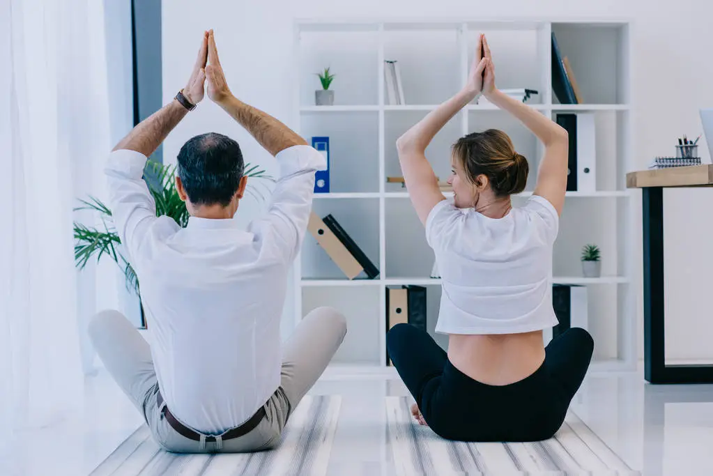 Businessman with his trainer practicing yoga and see how our write for us yoga and write for us lifestyle section guide more